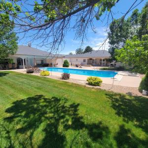 a house with a swimming pool in a yard at Monument Resort in Grand Junction