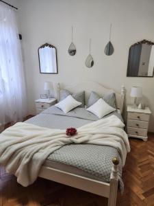 a bedroom with a bed with a blanket on it at Central old town escape in Timişoara