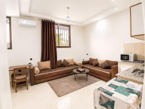 a living room with a couch and a table at Cosy in Marrakesh