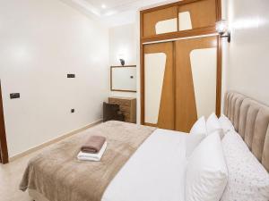 a bedroom with a bed with two towels on it at Cosy in Marrakesh