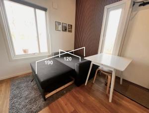 a living room with a table and a table and a window at The Fäxaåsen cabin in Varberg