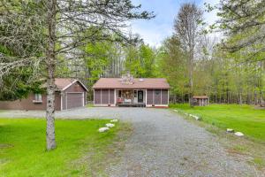 a house with a driveway in front of a yard at Peaceful Wooded Retreat at Lake Wallenpaupack! in Lake Ariel