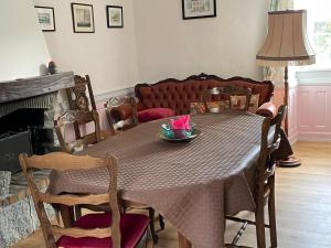 a dining room table with a bowl of flowers on it at Kerannie in Lanvollon +4 photos