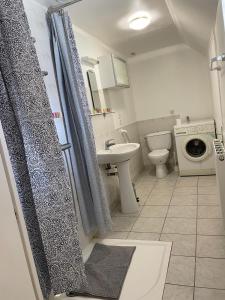 a bathroom with a shower and a toilet and a sink at Kerannie in Lanvollon