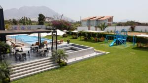 an outdoor patio with a pool and a playground at Awqa Loft & Camp in Trujillo