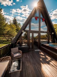 a gazebo with a bench on a deck at Valdo Cabin in Sadu