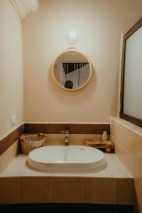 a bathroom with a large bath tub with a mirror at Taura Wellness House - Boutique Stay & Experiences in Antigua Guatemala in Antigua Guatemala +19 photos