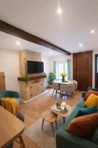 a living room with a blue couch and a tv at Maison de rue: Auch in Auch