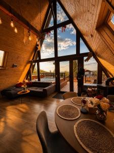 a living room with a table and a large window at Valdo Cabin in Sadu