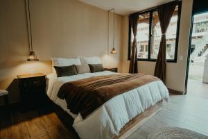 a bedroom with a large bed and a window at Taura Wellness House - Boutique Stay & Experiences in Antigua Guatemala in Antigua Guatemala