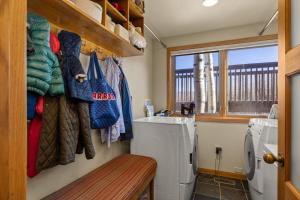 a laundry room with a washing machine and a window at 229 #35 by SkyRun Aspen in Snowmass Village