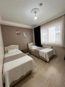 a bedroom with two beds and a window at Lale Residence in Trabzon +2 photos