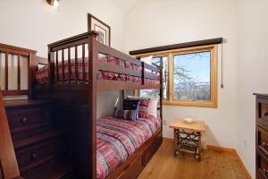 a small bedroom with a bunk bed and a window at 229 #36 by SkyRun Aspen in Snowmass Village