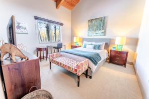 a bedroom with a bed and a dog standing on a table at 229 #36 by SkyRun Aspen in Snowmass Village