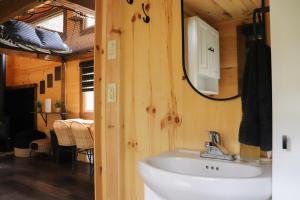 a bathroom with a sink and a mirror and a table at Exode en Nature in Sainte-Rose-du-Nord +220 photos