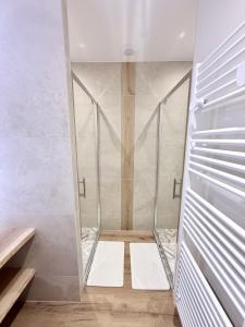 a walk in shower with glass doors and white walls at L'escale de l'oisans in Livet-et-Gavet +58 photos