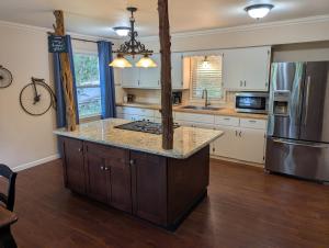 a kitchen with a large island in the middle at Lazy Bull Cottages in Bull Shoals