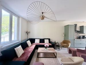 a living room with a couch and a table at L'escale de l'oisans in Livet-et-Gavet