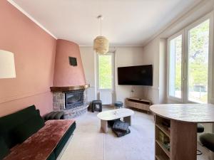 a living room with a couch and a fireplace at L'escale de l'oisans in Livet-et-Gavet