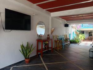 a living room with a flat screen tv on a wall at Milimar Hostal in San Onofre