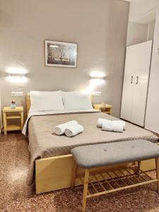 a bedroom with a bed with two towels on it at Apartments Papadioti in Pefki