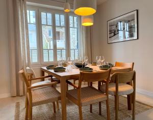 a dining room with a wooden table and chairs at GIte de la Grande Plage in Pléneuf-Val-André