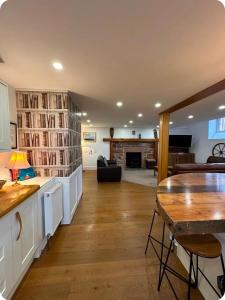 a living room with a library with a table and chairs at Chapel House Accommodation in Culgaith