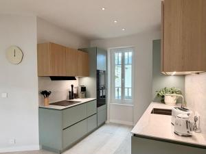 a kitchen with green cabinets and a counter top at GIte de la Grande Plage in Pléneuf-Val-André +24 photos