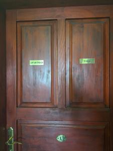 a wooden door with two signs on it at Apartment Tara in Igalo