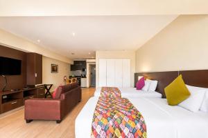a hotel room with a large bed and a couch at Diez Canseco by 2W Aparments Service in Lima