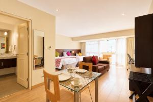 a living room with a couch and a table in a room at Diez Canseco by 2W Aparments Service in Lima