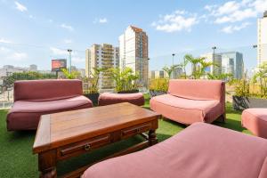 a patio with chairs and a coffee table on a roof at Diez Canseco by 2W Aparments Service in Lima