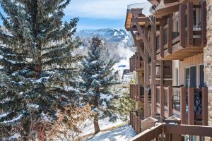 a view from the balcony of a resort in the snow at 29C by SkyRun Aspen in Snowmass Village