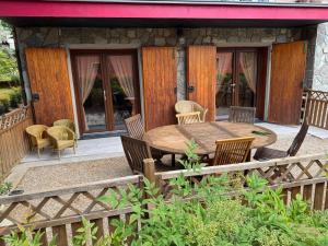 a patio with a wooden table and chairs at B&B Borgo dei Cedri in Pontecchio