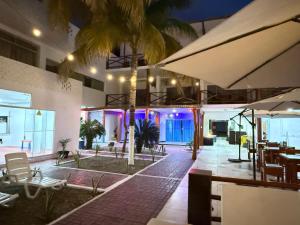 a restaurant with tables and chairs and umbrellas at Hotel Las Terrazas de Bonanza in Zorritos