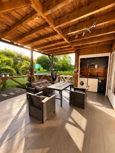a covered patio with a table and chairs at evasion guadeloupe in Malgré Tout