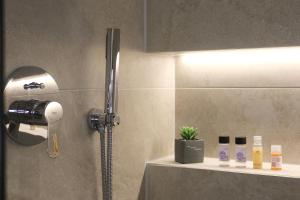 a bathroom with a shower with a light on the wall at Megan's Villa in Durrës +82 photos