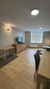 an empty room with a tv and a table and chairs at Superbe Duplex T2 62m2 - Rénové à Neuf ! in Croix