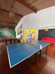a ping pong table in the middle of a living room at RioVermelhopoint in Salvador