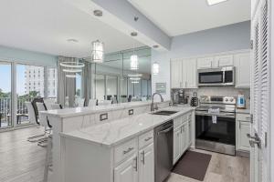 a kitchen with white cabinets and a large kitchen island at TOPS'L Tides 0207 in Destin