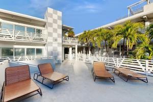 a group of chairs sitting in front of a building at Sunshine, Beach & Smiles on Ocean Drive in Miami Beach