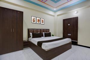 a bedroom with a large bed in a room at Hotel O by OYO SGD Lawn And Hotel in Varanasi +23 photos