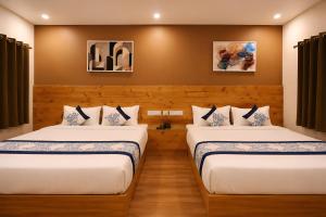 two beds in a room with wooden walls at The Grand Uddhav - a botique hotel in Udaipur +33 photos