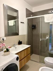 a bathroom with a sink and a shower at Casa in Centro con Giardino in Imola +13 photos