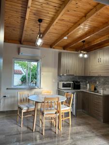 a kitchen and dining room with a table and chairs at Liberty Home Μάκρη in Alexandroupoli