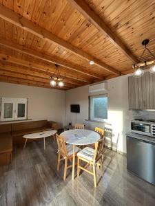 a kitchen and dining room with a table and chairs at Liberty Home Μάκρη in Alexandroupoli +17 photos