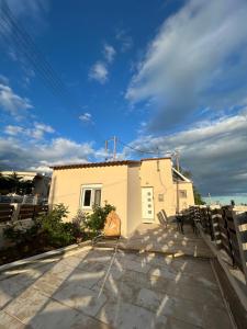 a white house with a fence in front of it at Liberty Home Μάκρη in Alexandroupoli