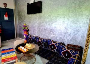 a living room with a couch and a table at Appart Ennakhil 4 avenue mohamed 6 in El Jadida