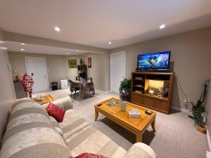 a living room with a couch and a flat screen tv at Green House in St. John's