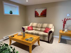 a living room with a couch and a coffee table at Green House in St. John's +22 photos